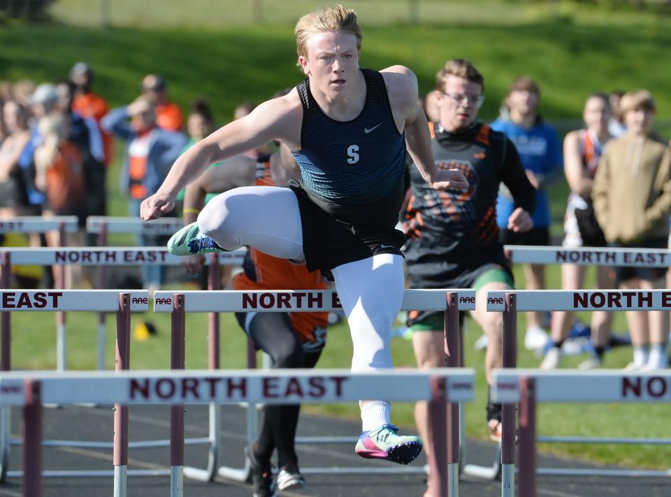 Seneca High School senior Ryan Miller wins a boys 110-meter hurdle preliminary race during the North East Track & Field Invitational in North East on Saturday. Miller later won the event finals race.