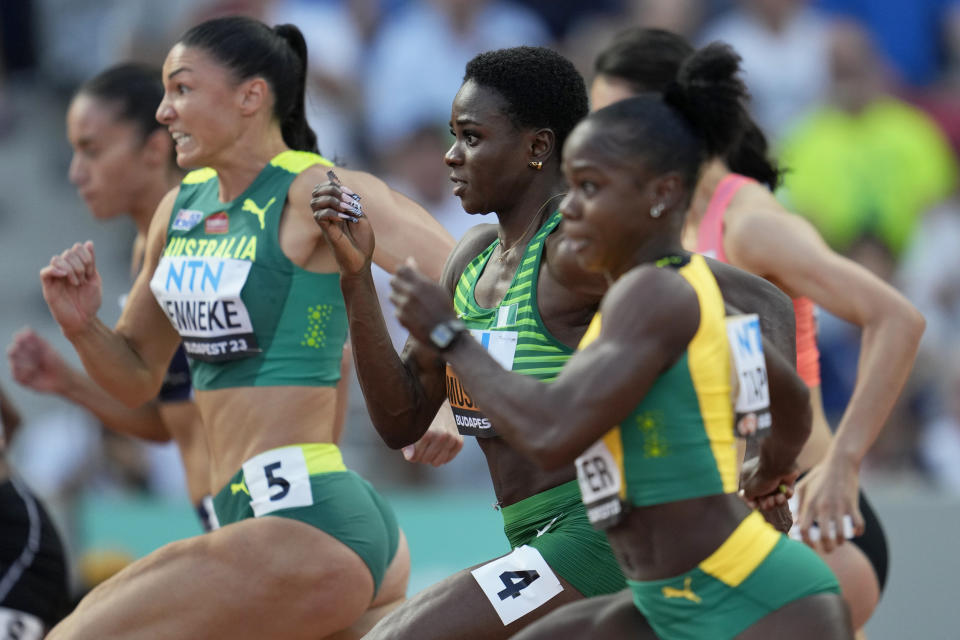 Tobi Amusan, of Nigeria, center, competes in a Women's 100-meter hurdles heat during the World Athletics Championships in Budapest, Hungary, Tuesday, Aug. 22, 2023. (AP Photo/Ashley Landis)