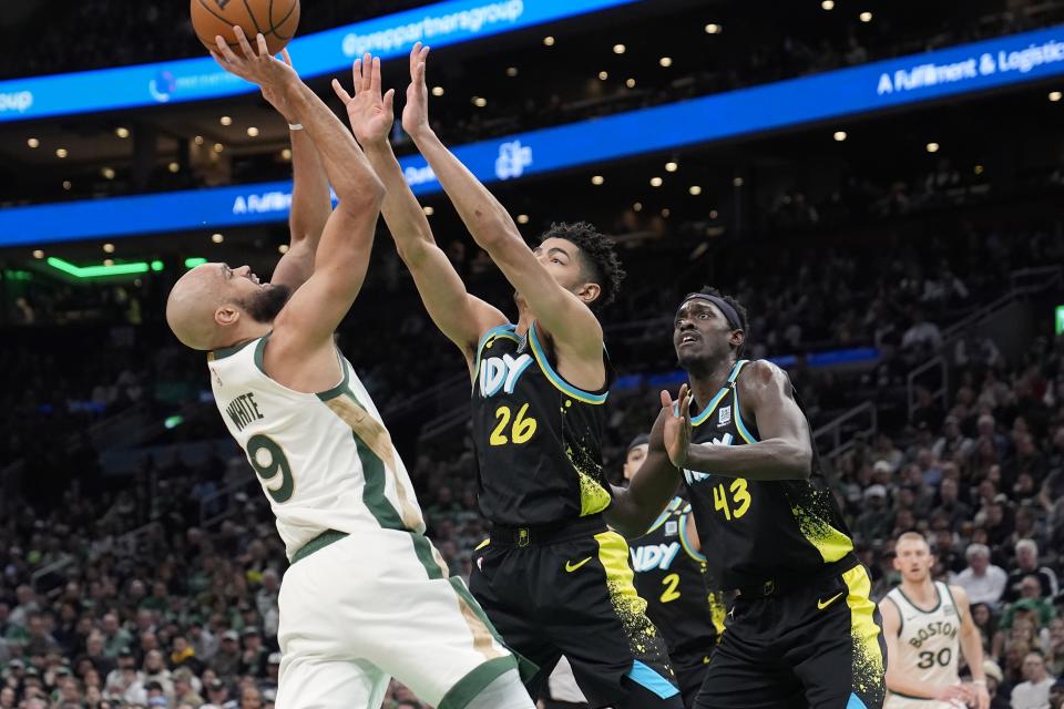 Boston Celtics' Derrick White (9) shoots against Indiana Pacers' Ben Sheppard (26) during the first half of an NBA basketball game, Tuesday, Jan. 30, 2024, in Boston. (AP Photo/Michael Dwyer)