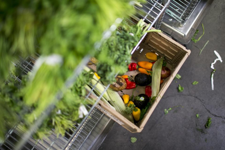 People fill carts full of donated food at the United Food Bank on Sept. 6, 2019, in Mesa, Ariz.