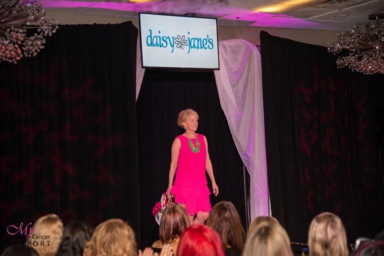 Wendy McCoole, breast cancer survivor and the founder of My Breast Cancer Support models a summer outfit from Daisy Janes at the start of the Fashion show.
