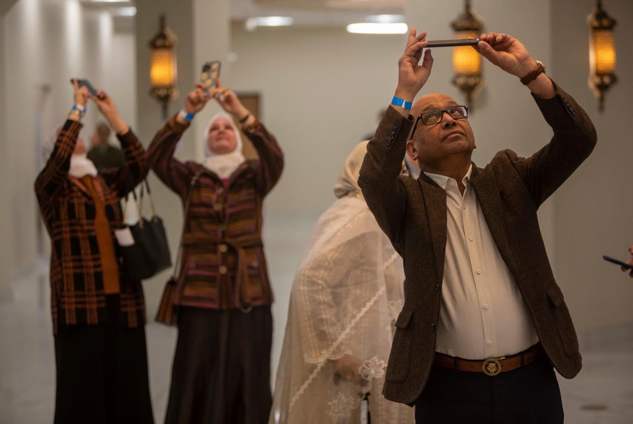 Saleem Siddiqui takes a photo of a large chandelier hanging inside the Islamic Association of Greater Detroit's (IAGD) newly expanded mosque in Rochester Hills on Saturday, March 2, 2024. The chandelier is part of a $20 million expansion of one of metro Detroit's largest mosques.