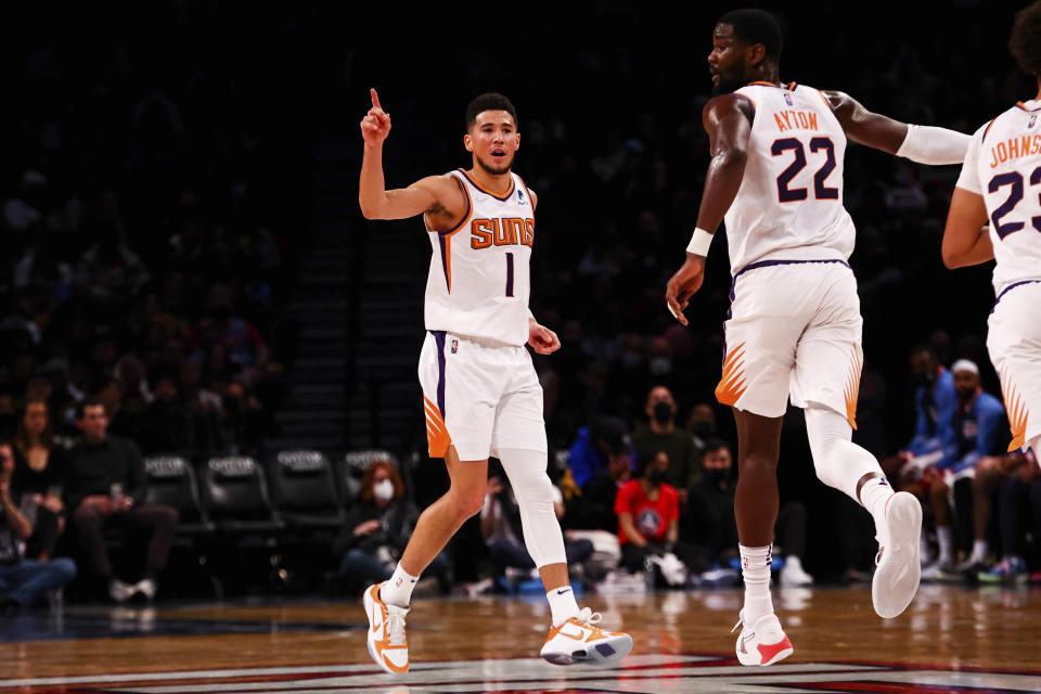 Phoenix Suns guard Devin Booker (1) reacts during the second half of an NBA basketball game against the Brooklyn Nets, Saturday, Nov. 27, 2021, in New York. (AP Photo/Jessie Alcheh)