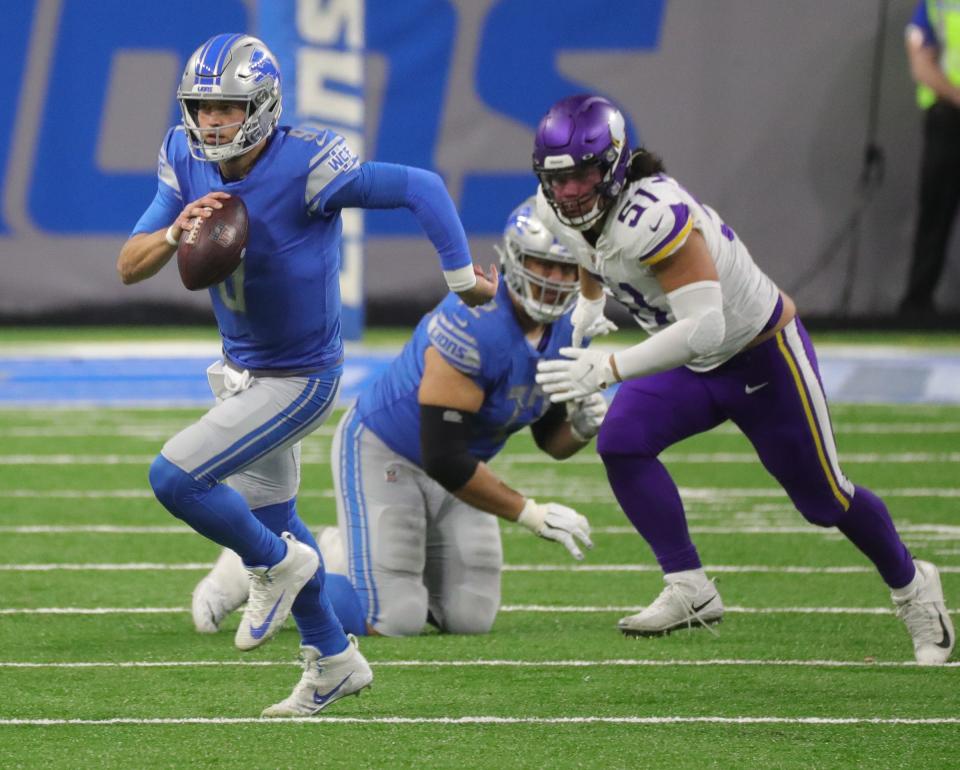 Detroit Lions quarterback Matthew Stafford runs by Minnesota Vikings defensive tackle Hercules Mata'afa (51) during the first half at Ford Field, Sunday, Jan. 3, 2021.