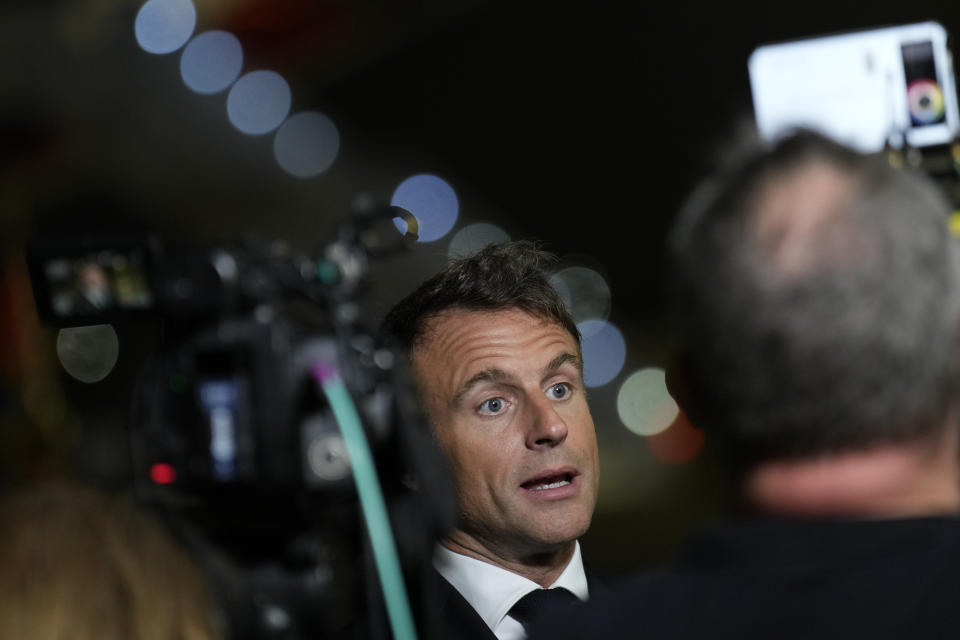 French President Emmanuel Macron talks to journalists on the tarmac of Cairo airport, Egypt, as he departs Wednesday, Oct. 25, 2023. French President Emmanuel Macron sought to promote, yet with little success, the prospect of creating an "international coalition" to fight against the armed Palestinian militant group Hamas, during a two-day trip to the Middle East that started in Israel. (AP Photo/Christophe Ena, Pool)