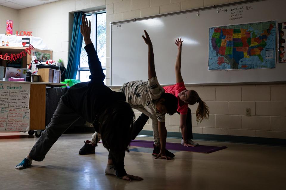 Sixth grade teacher Cindy Sanchez leads yoga in her classroom during a voluntary half-day at John S. Gillett Middle School on Friday, Feb. 9, 2024, in Kingsville, Texas.