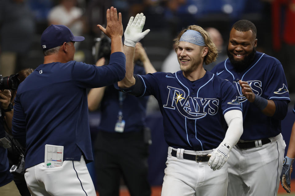 Tampa Bay Rays' Taylor Walls, right, celebrates with manager Kevin Cash after hitting a home run against the St. Louis Cardinals during the 10th inning of a baseball game Tuesday, June 7, 2022, in St. Petersburg, Fla. (AP Photo/Scott Audette)
