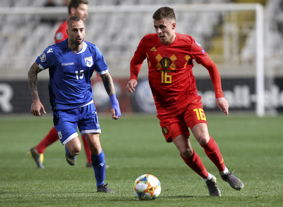 Cyprus' Fotis Papoulis, left, right, fights for the ball with , Belgium's Thorgan Hazard,right, during the Euro 2020 group I qualifying soccer match between Cyprus and Belgium at the GSP stadium in Nicosia, Cyprus, Sunday, March 24, 2019. (AP Photo/Philippos Christou)