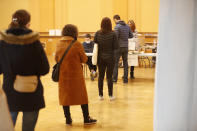 Residents queue to vote for the municipal elections, in Strasbourg, eastern France, Sunday March 15, 2020. The new virus has shuttered all schools, banished cheek-kissing and upended daily life across France, but President Emmanuel Macron won't let it disrupt democracy, so he's maintaining nationwide elections this weekend. For most people, the new coronavirus causes only mild or moderate symptoms. For some it can cause more severe illness. (AP Photo/Jean-Francois Badias)