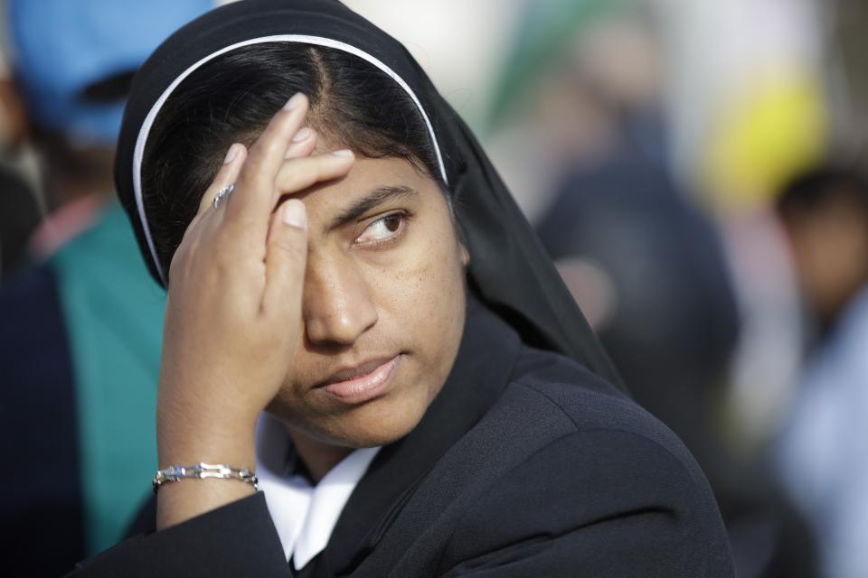 A nun waits for the start of a canonization Mass in St. Peter's Square at the Vatican, Sunday, Oct. 13, 2019. Pope Francis canonizes Cardinal John Henry Newman, the 19th century Anglican convert who became an immensely influential thinker in both Anglican and Catholic churches, and four other women. (AP Photo/Alessandra Tarantino)