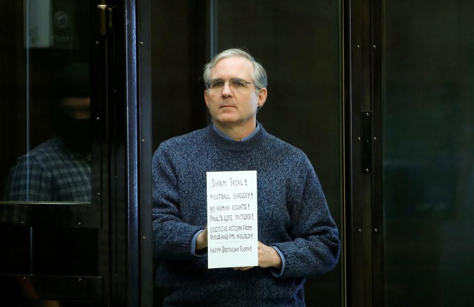 American detainee Paul Whelan holds a sign ahead of a hearing in Moscow.