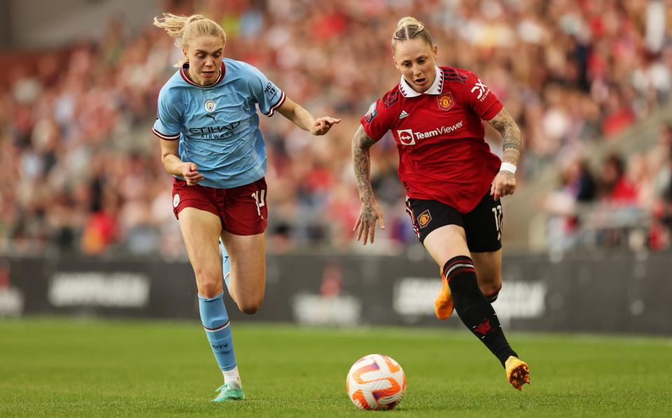 Leah Galton of Manchester United runs with the ball while under pressure from Esme Morgan of Manchester City during the FA Women's Super League match between Manchester United and Manchester City at Leigh Sports Village on May 21, 2023 in Leigh, England