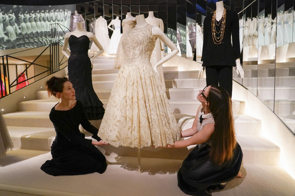 Curators adjust a creation which is displayed as part of the "Gabrielle Chanel. Fashion Manifesto" exhibition at the Victoria and Albert museum, in London, Tuesday, Sept. 12, 2023.(AP Photo/Alberto Pezzali)