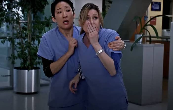 Meredith Grey and Cristina Yang from "Grey's Anatomy" looking horrified at a scene unfolding in front of them