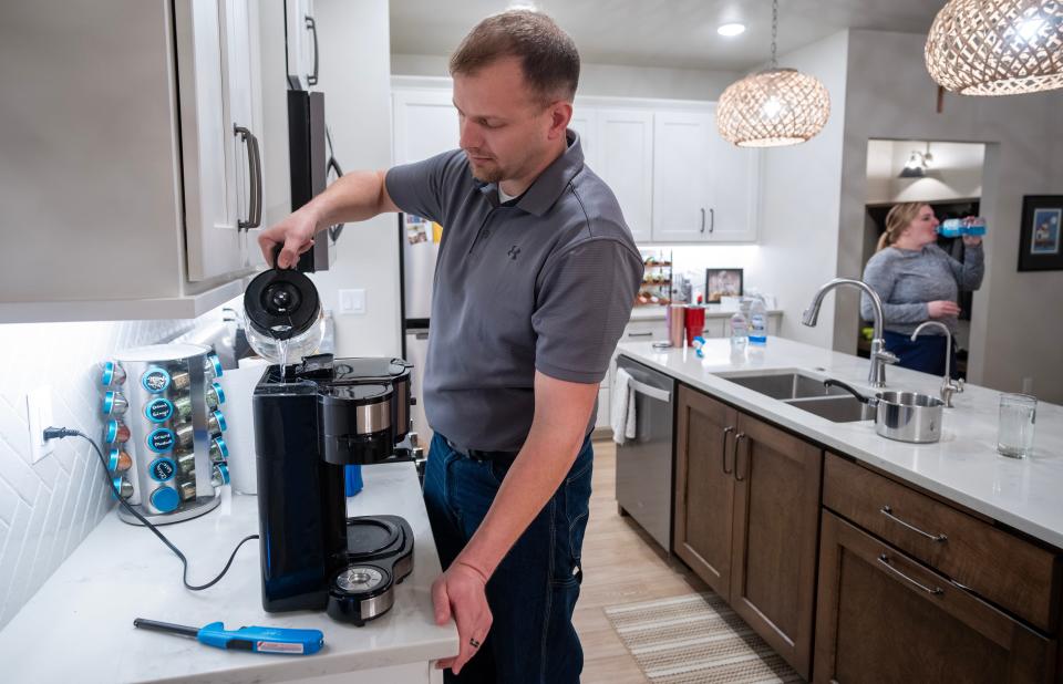 Tyler Frye fills his coffee maker with water processes by a reverse osmosis machine Monday, February 5, 2024 in Casco, Wisconsin. The reverse osmosis greatly reduces the amount of nitrates in their water. Newlyweds Tyler and Shannon Frye recently bought their brand new house and discovered their well is contaminated with high levels of nitrates. The contaminated water is a problem for the entire Kewaunee County village which has no municipal water supply.



Mark Hoffman/Milwaukee Journal Sentinel