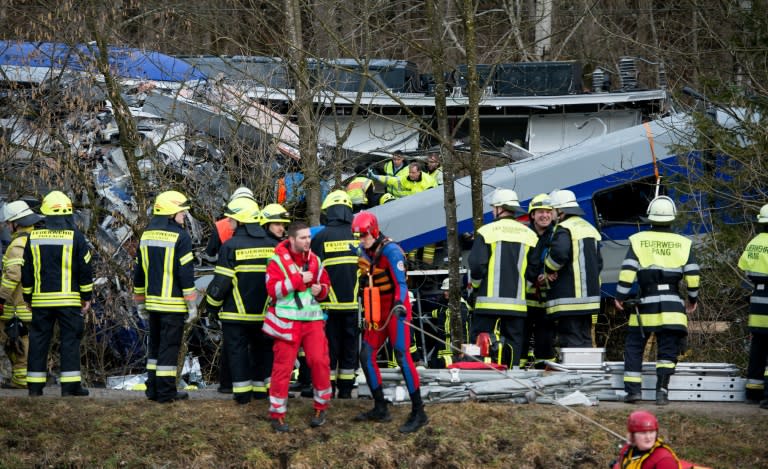 Firefighters and emergency doctors work at the site of a train crash near Bad Aibling, southeast Germany, on February 9, 2016