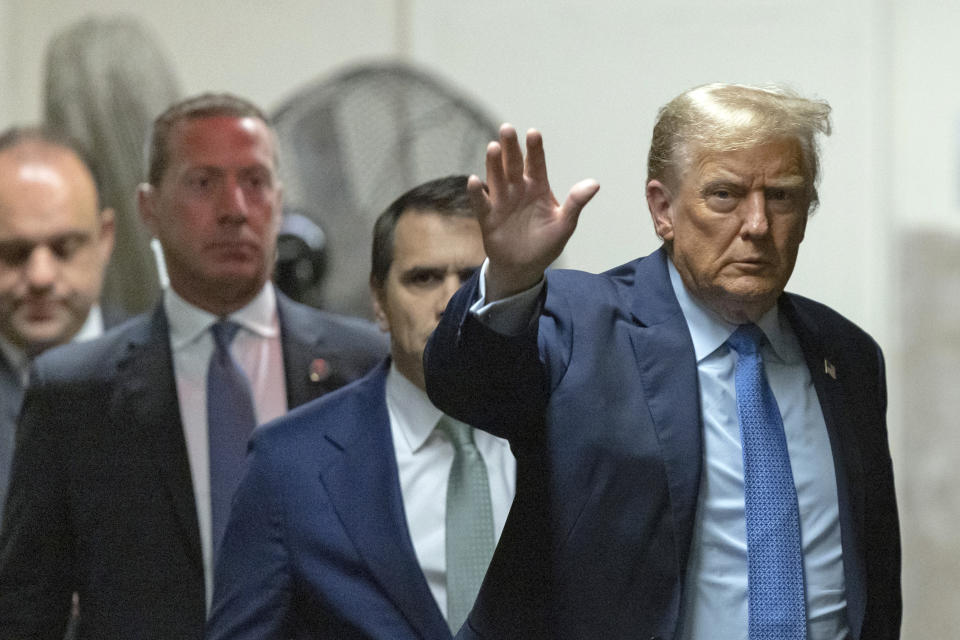 Former President Donald Trump waves to the media as he returns from a break during his trial at Manhattan criminal court , Friday, April 26, 2024, in New York. (Jeenah Moon/Pool Photo via AP)