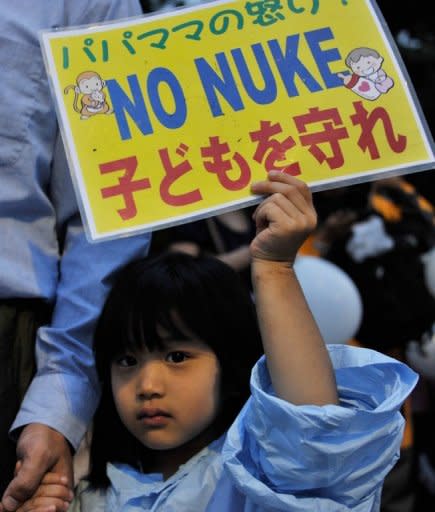 A girl holds up a banner denouncing nuclear power plants during a demonstration in front of the official residence of Japanese Prime Minister Yoshihiko Noda in Tokyo on Friday. Jiji Press news agency estimated the rally, which has been held every Friday since late March, to be around 7000