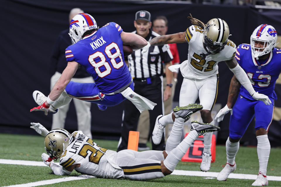 Buffalo Bills tight end Dawson Knox (88) scores a touchdown against New Orleans Saints cornerback Marshon Lattimore (23) and cornerback Bradley Roby (21) in the second half of an NFL football game in New Orleans, Thursday, Nov. 25, 2021. (AP Photo/Butch Dill)