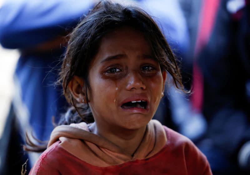 FILE PHOTO: A girl mourns the death of a family member who died during an earthquake in Jajarkot