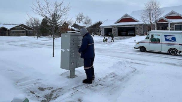 PHOTO: A United States postal worker delivers mail in Ames, Iowa, on Dec. 22, 2022. At the time, the National Weather Service reported the wind chill in Ames was minus 35 degrees. (Teresa Kay Albertson/The Ames Tribune via USA Today Network)