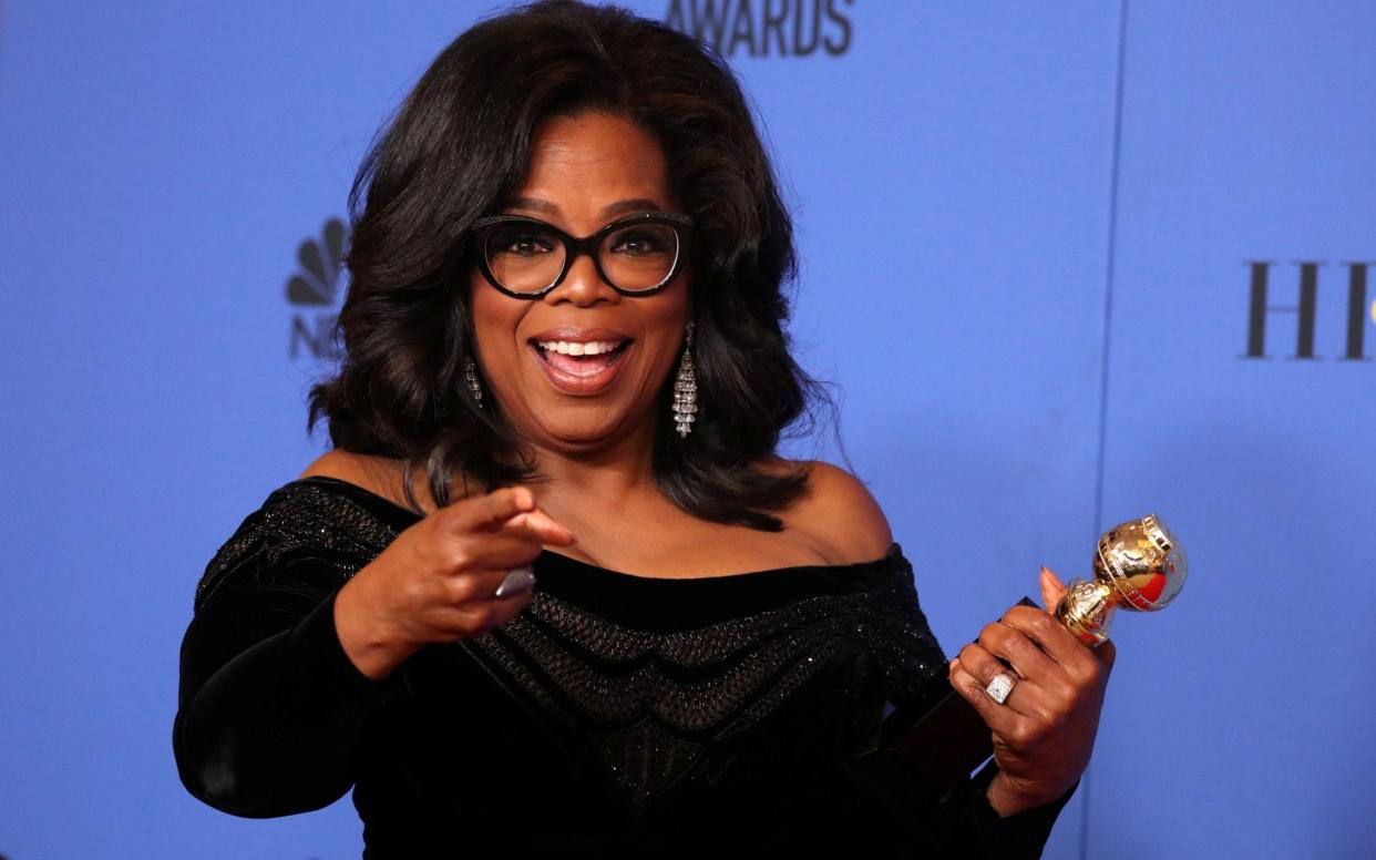 Oprah Winfrey poses backstage with her Cecil B. DeMille Award at the Golden Globes - REUTERS