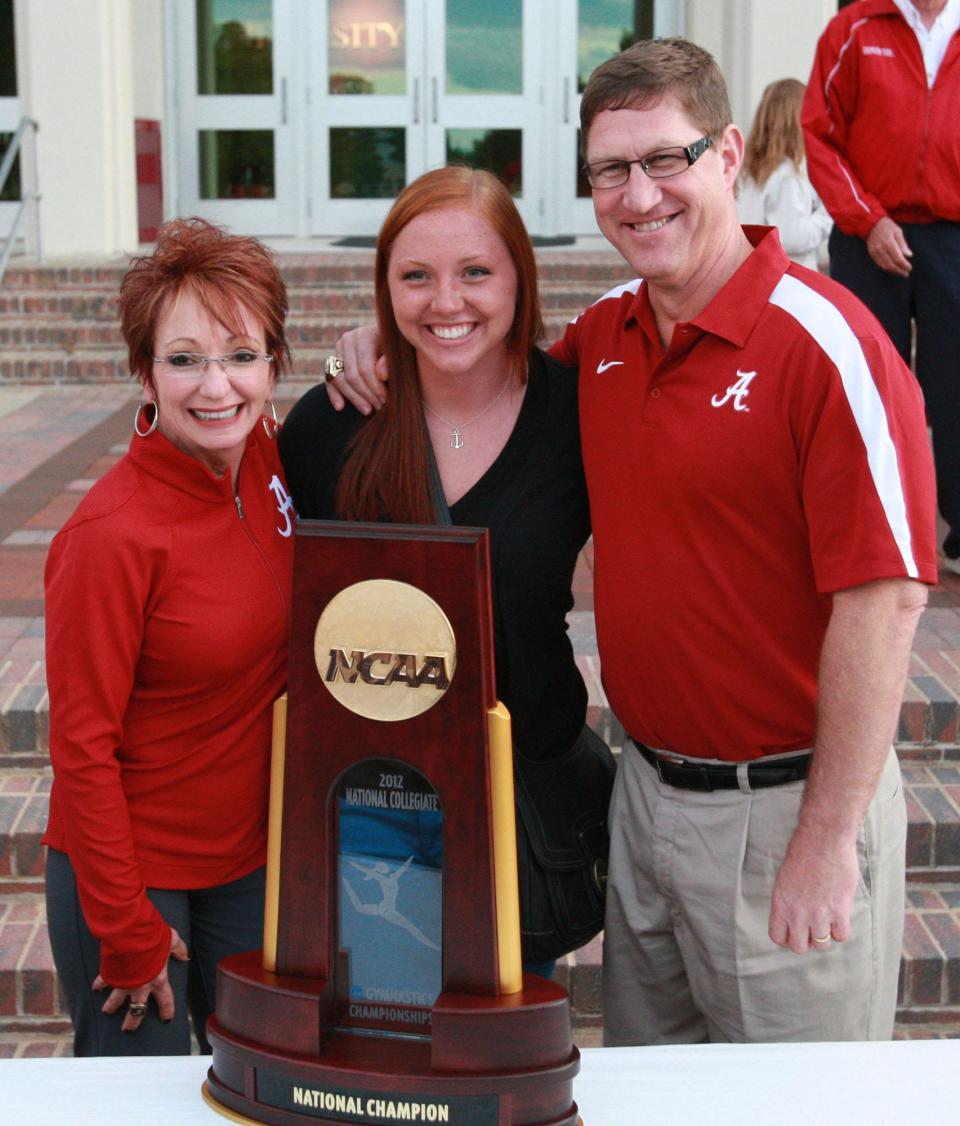 University of Alabama head coaches Sarah and David Patterson pose with their daughter Jordan with the 2102 national championship trophy in front of Coleman Coliseum on Sunday upon their arrival back in Tuscaloosa from the national championships in Duluth, Georgia. The Pattersons have been selected as the United Way's Alexis de Tocqueville Family of the Year for 2023. (Photo: T.G. Paschal-Tuscaloosa News)