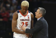 Virginia head coach Tony Bennett talks with forward Mamadi Diakite (25) after he fouled out during the second half of an NCAA college basketball game in Charlottesville, Va., Sunday, Dec. 8, 2019. Virginia defeated North Carolina 56-47. (AP Photo/Steve Helber)