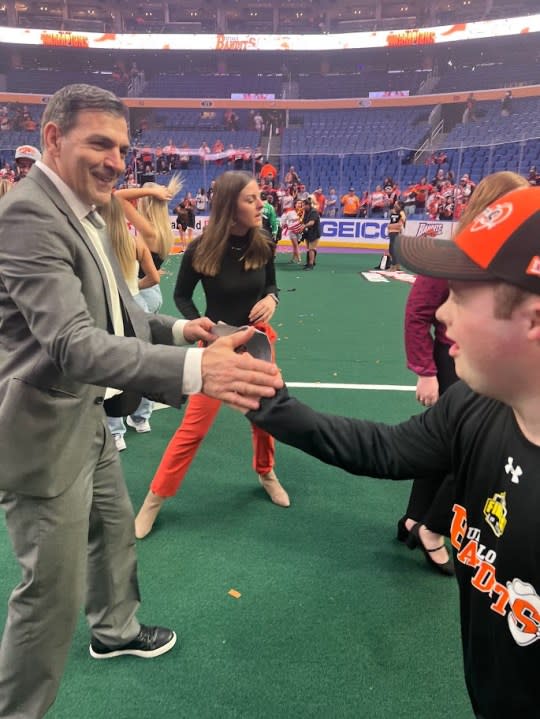 Bandits head coach John Tavares and ball boy Brett Swenson perform their handshake after the team’s NLL title win in June 2023.