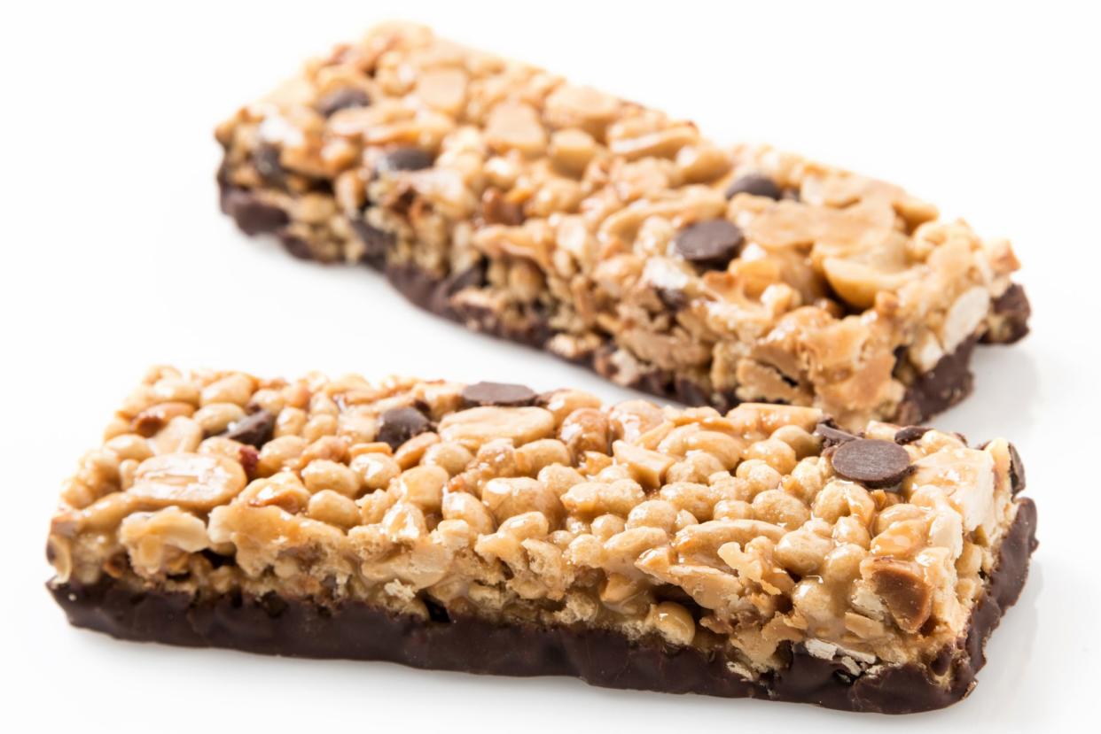 Chocolate and peanut butter energy bar close up on white background