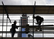 Workers erect the photo bridge at the finish of the New York City Marathon, in New York's Central Park, Friday, Nov. 2, 2012. The course for Sunday's New York City Marathon will be the same since there was little damage but getting to the finish line could still be an adventure for runners from outlying areas. Such is life in Sandy's aftermath disrupted trains, planes, buses and ferries, flooded buildings, blocked roads and knocked out power. (AP Photo/Richard Drew)