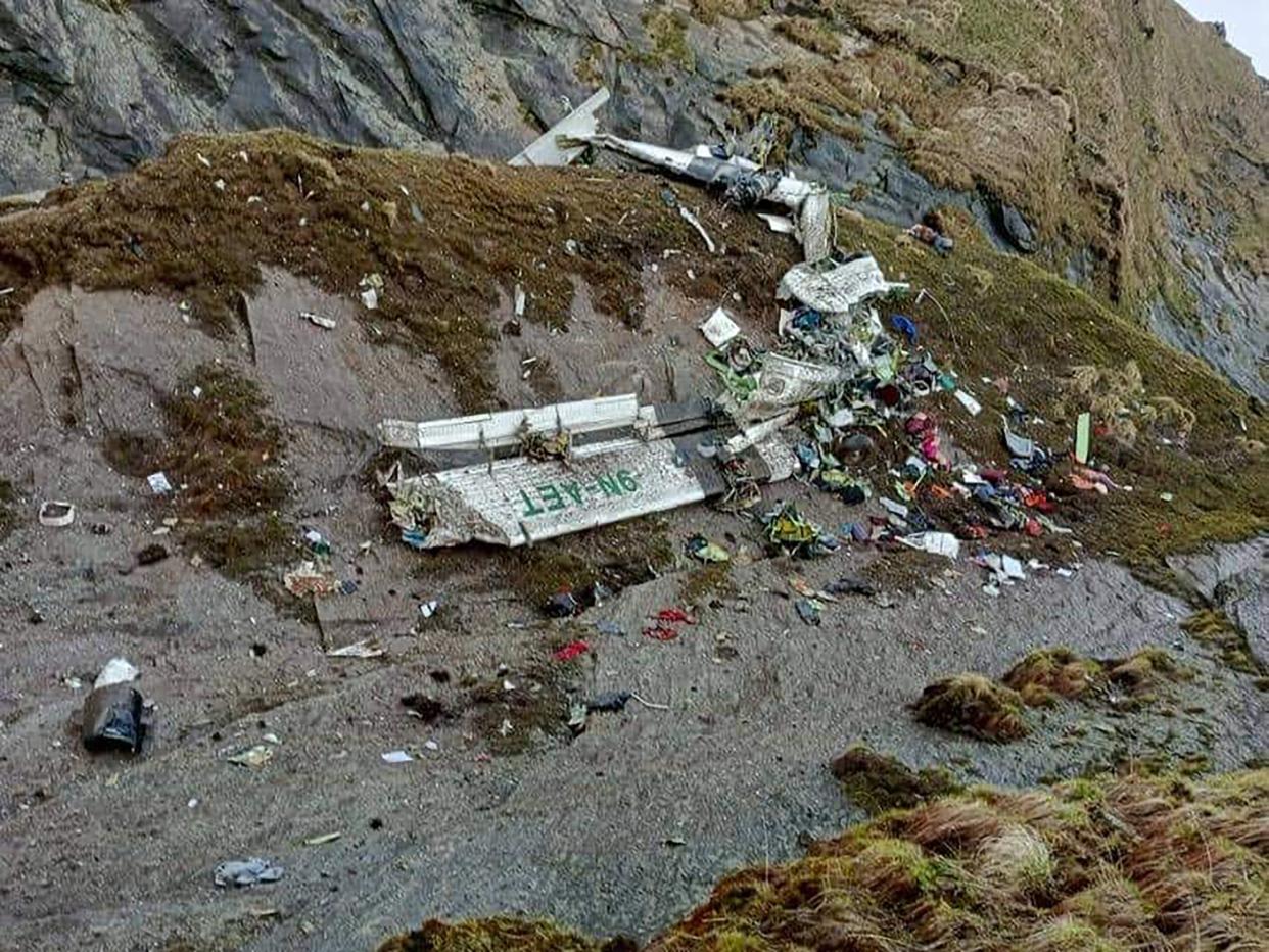 This handout photograph released by Fishtail Air, shows the wreckage of a plane in a gorge in Sanosware in Mustang district close to the mountain town of Jomsom, west of Kathmandu, Nepal, Monday, May 30, 2022. 