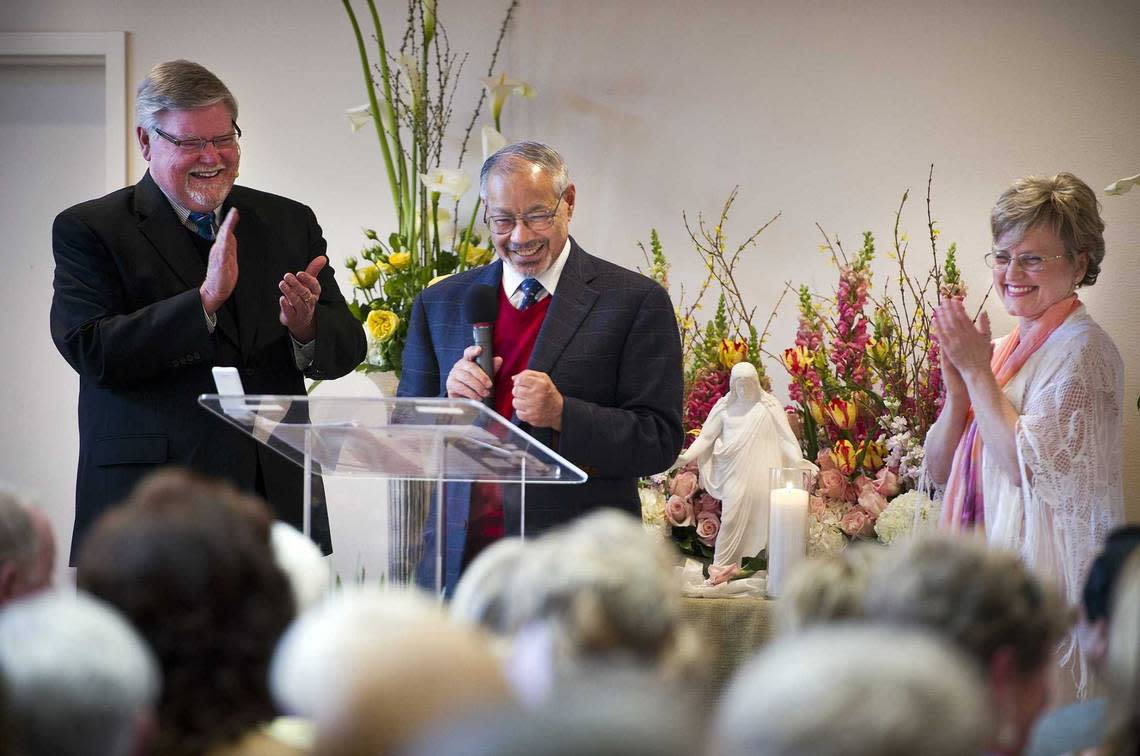 The Revs. Michael Moran, left, and Christine Bouten, right, of the Spiritual Life Center applaud Dr. Metwalli Amer, executive director and founder of SALAM, as he greets the members of the Christian congregation for their 2012 Easter services, held at the SALAM Islamic Center. Moran, who co-founded Spiritual Life Center, died March 24 at his home in Idaho. He was 75.