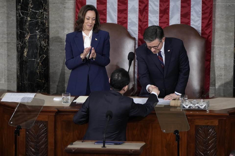 Japan's Prime Minister Fumio Kishida shakes hands with Speaker of the House Mike Johnson, R-La., before ddressing a joint meeting of Congress in the House chamber, Thursday, April 11, 2024, at the Capitol in Washington, as Vice President Kamala Harris looks on. (AP Photo/Jacquelyn Martin)