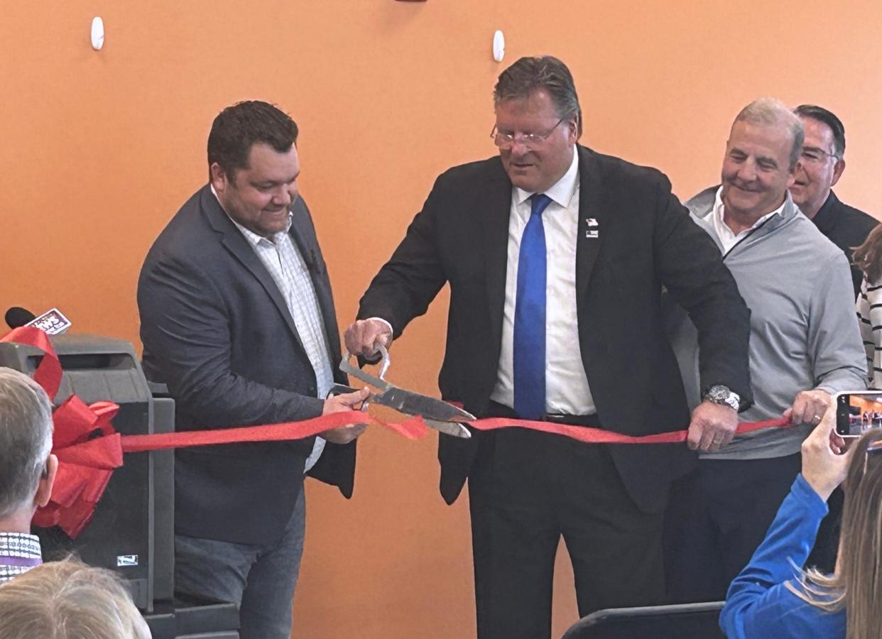 Phill West, senior director of planning, logistics and customer fulfillment for General Mills, left, and Belvidere Mayor Clint Morris, center, cut a red ribbon Tuesday, April 16, 2024, to mark the opening of the company's new 1.3-million-square-foot warehouse and distribution at 1210 Irene Road in Belvidere.