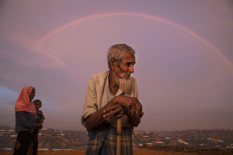 <p>Abu Siddique, 90, stands on a hill overlooking the Kutupalong refugee camp, as a rainbow covers the sky on September 22, 2017. He spent all of his savings to pay people to carry him across the Myanmar border to Bangladesh. (Photograph by Paula Bronstein/UNHCR) </p>