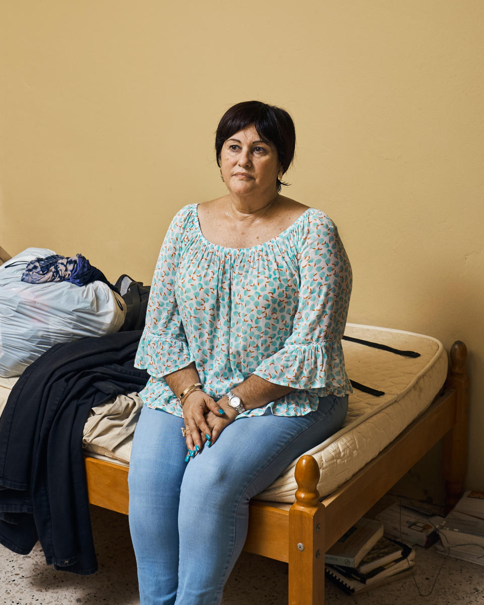 Zilma Maldonado poses in her son Miguel García's room in Utuado on Aug. 31. He and his brother left after the hurricane.