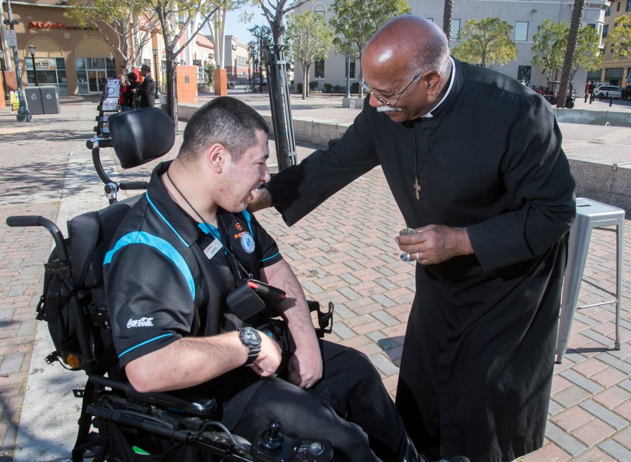 Gabriel Soto, left, is blessed by Deacon Stephen Bentley with St. John the Evangelist Episcopal Church at the church's Ashes to Go event at Janet Leigh Plaza in downtown Stockton on Feb. 26, 2020.