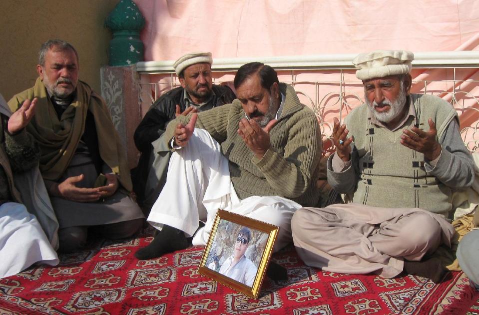 Pakistani villagers pray for 17-year-old student Aitzaz Hasan, who residents and police say died this week while trying to stop a suicide bomber who was targeting his school in a remote village in Hangu, Pakistan, Friday, Jan. 10, 2014. Police said a teacher at the school told investigators that he saw Hasan chasing the attacker and then saw the attacker detonate the bomb that killed the teen. Local resident Miqdar Khan said people in the violence-prone district were hailing the teen as a hero.(AP Photo/Abdul Rehman)