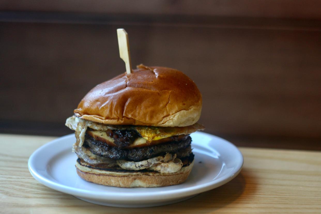 The Whole Farm burger — one-third-pound patty topped with smoked Gouda, crispy fried red onion, over-medium egg and jalapeno-bacon jam — from Zaftig Brew Pub.