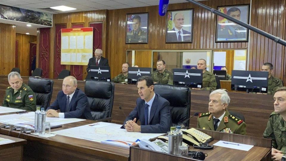 This image released by the Syrian Presidency shows Russian President Vladimir Putin, center left, in a meeting with Syrian President Bashar Assad, third right, in Damascus, Syria on Tuesday, Jan. 7, 2020. Putin visited Syria on Tuesday and met with officials including Assad, Syrian state media and a Kremlin spokesman reported. Putin's visit is the second to the war-torn country where his troops have been fighting alongside Syrian government forces since 2015. (Syrian Presidency via AP)