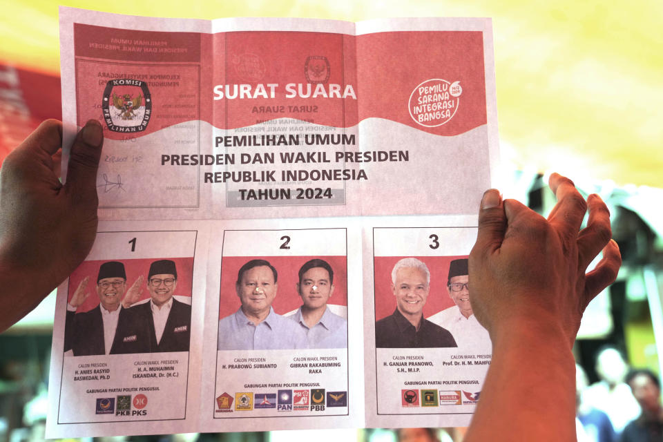 FILE - An electoral worker holds up a ballot showing a vote for presidential candidate Prabowo Subianto and his running mate Gibran Rakabuming Raka, the eldest son of Indonesian President Joko Widodo, during the vote counting at a polling station following the election in Jakarta, Indonesia, Wednesday, Feb. 14, 2024. Subianto’s rise as Indonesia’s apparent next president is a dramatic comeback from a notorious past, which saw the United States banning his entry over human rights and the Indonesian army, where he led the special forces, expelling him. (AP Photo/Tatan Syuflana, File)