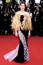 in Dior Haute Couture gown and Erik Halley feather cape