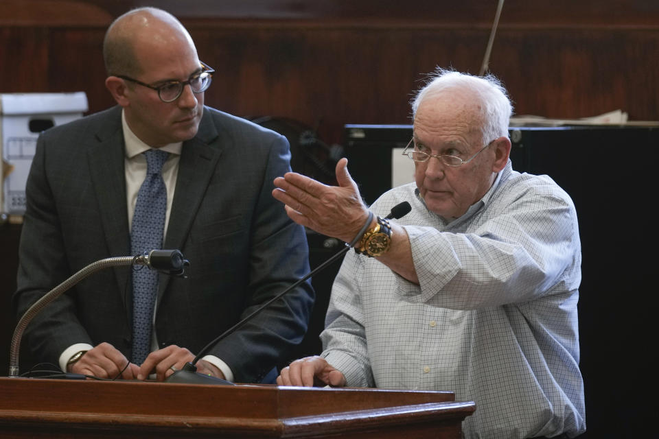 Jim Martin, brother of Diane Cusick, reads a statement with prosecutor Jared Rosenblatt at his side at a courtroom in Mineola, N.Y., Monday, Dec. 5, 2022. Richard Cottingham, the serial murderer known as the "Torso Killer", admitted Monday to killing Cusick, a 23-year-old woman, outside a Long Island shopping mall in 1968 and four other women decades ago. (AP Photo/Seth Wenig)