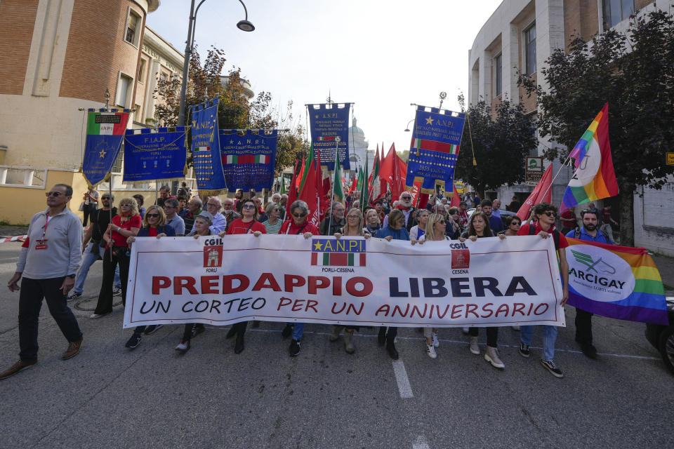 People hold a banner reading, Predappio Free, during a march organized by the Italian Partisans association in Mussolini's birthplace Predappio Friday, Oct. 28, 2022, to mark the 78th anniversary of the liberation of the town from the nazi-fascist occupation by Italian Partisans and Polish allied troops, which coincides with the 100th anniversary of the march on Rome. (AP Photo/Luca Bruno)
