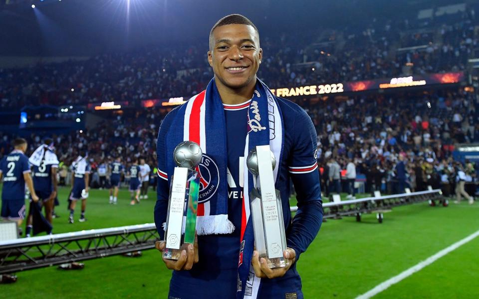 Kylian Mbappé of Paris Saint-Germain poses with the best scorer and best passer trophies after the Ligue 1 Uber Eats match between Paris Saint Germain and FC Metz at Parc des Princes on May 21, 2022 in Paris, France - GETTY IMAGES