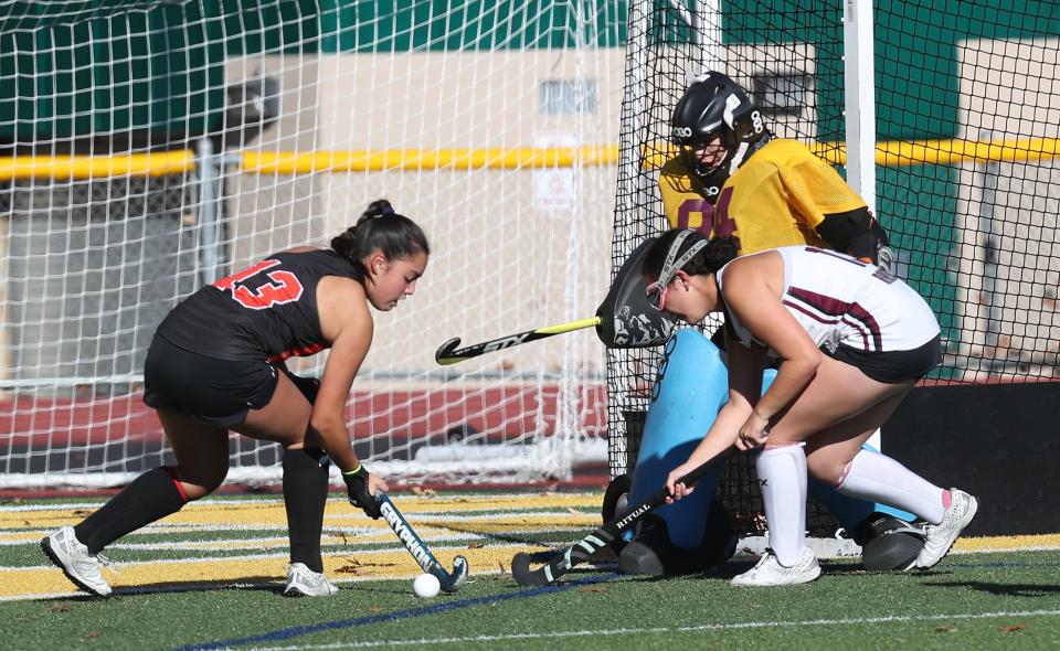 From left, Mamaroneck's Bella LaPorta (13) tries to get a shot by Scarsdale goalie Gabriella Lopez (94) during the Section 1 Class A field hockey championship at Lakeland High School in Shrub Oak Oct. 29, 2022. 