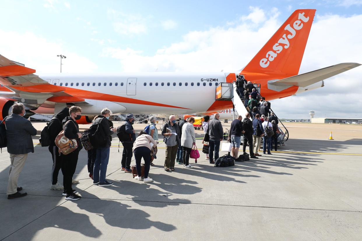 People board an EasyJet flight at Gatwick Airport