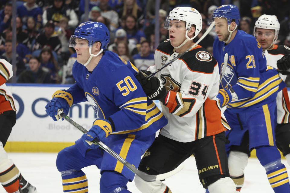 Buffalo Sabres left wing Eric Robinson (50) and Anaheim Ducks defenseman Pavel Mintyukov (34) battle for position during the first period of an NHL hockey game Monday, Feb. 19, 2024, in Buffalo, N.Y. (AP Photo/Jeffrey T. Barnes)