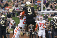 Wake Forest wide receiver A.T. Perry (9) misses a catch as he is hit by Clemson cornerback Nate Wiggins (20) during the first half of an NCAA college football game in Winston-Salem, N.C., Saturday, Sept. 24, 2022. Wiggins was called for pass interference on the play. (AP Photo/Chuck Burton)